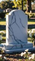A marble tombstone sits in the grass photo