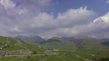 Dramatic Cloud Flow Over Rugged Mountains in Timelapse video