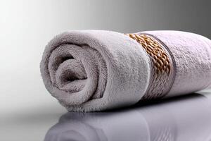 Soft bath towel neatly rolled and placed on a clean surface for a spa-like ambiance photo