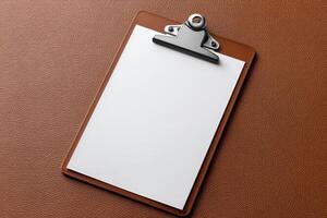 Blank clipboard resting on a textured brown surface waiting for important notes or documents photo