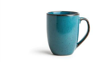 Bright blue ceramic mug on white surface with subtle texture and warm tones photo