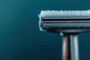 Razor covered in frost resting against a blue background in a cool atmosphere photo