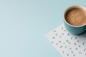 Calculator for invoice calculations next to a cup of coffee on a pastel background photo
