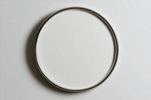 Circular white plate with silver rim displayed on a plain background in a neutral setting photo