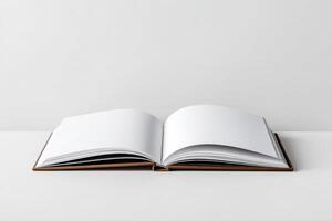 Open blank book displaying empty pages on a minimalist surface in a bright setting photo