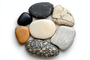 Arrangement of various smooth stones on a white background for decorative purposes photo
