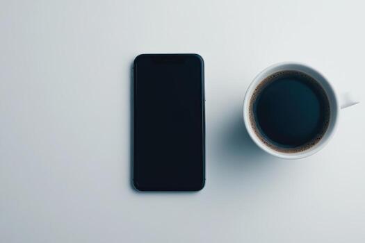 Coffee and smartphone on a minimalist table in morning light photo