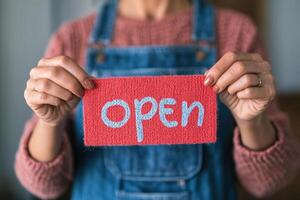 Hanging open sign displayed on glass door in a charming shop environment photo