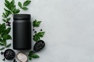 Black container surrounded by herbal ingredients on a gray surface photo