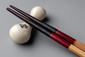 Elegant chopsticks resting on a ceramic holder for a minimalist dining experience photo