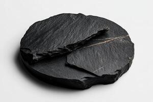 Natural black stone pieces arranged on a white surface for a minimalist aesthetic display photo