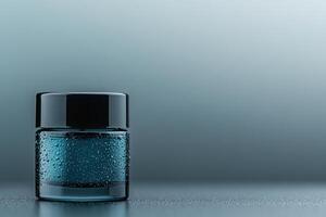Elegant glass jar with condensation showcasing a serene blue liquid on a minimalistic backdrop photo