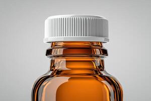 Clear glass bottle filled with amber liquid and white cap on a gray background photo