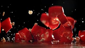 Dropping chopped chili peppers onto a board. Filmed on a high-speed camera at 1000 fps. High quality FullHD footage video