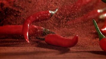 Red chili pepper in flight with ground pepper. Filmed on a high-speed camera at 1000 fps. High quality FullHD footage video