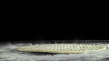 Making pizza. Pizza dough falls on the table. Filmed on a high-speed camera at 1000 fps. High quality FullHD footage video