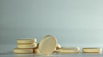 An aspirin tablet on the table. Filmed on a high-speed camera at 1000 fps. High quality FullHD footage video