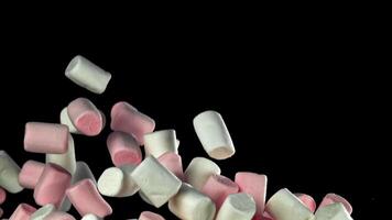 Pink and white marshmallows fly up and fall down. Filmed on a high-speed camera at 1000 fps. High quality FullHD footage video