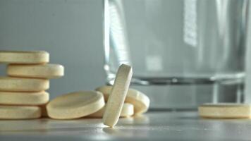An aspirin tablet on the table. Filmed on a high-speed camera at 1000 fps. High quality FullHD footage video