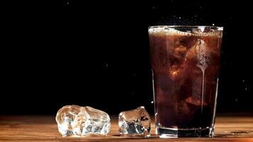 Bubbles in a glass of cola with ice. Filmed on a high-speed camera at 1000 fps. High quality FullHD footage video