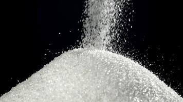 Sugar falls on the table in a heap. Filmed on a high-speed camera at 1000 fps. High quality FullHD footage video
