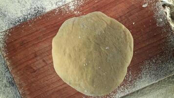Fresh dough falls on cutting board. View from above. Filmed on a high-speed camera at 1000 fps. High quality FullHD footage video