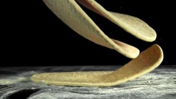Making pizza. Pizza dough falls on the table. Filmed on a high-speed camera at 1000 fps. High quality FullHD footage video