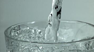 Water is poured into a glass. Filmed on a high-speed camera at 1000 fps. High quality FullHD footage video