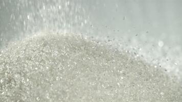 Sugar falls on the table in a heap. Filmed on a high-speed camera at 1000 fps. High quality FullHD footage video