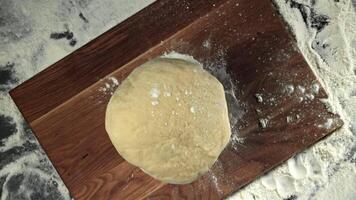 Fresh dough falls on cutting board. View from above. Filmed on a high-speed camera at 1000 fps. High quality FullHD footage video
