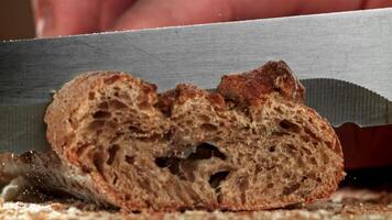 The chef slices bread. Fresh baguette sliced. Filmed on a high-speed camera at 1000 fps. High quality FullHD footage video