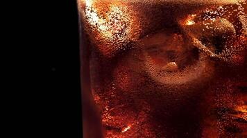 Bubbles in a glass of cola with ice. Filmed on a high-speed camera at 1000 fps. High quality FullHD footage video