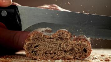The chef slices bread. Fresh baguette sliced. Filmed on a high-speed camera at 1000 fps. High quality FullHD footage video