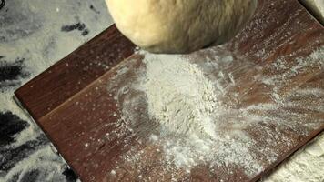 Fresh dough falls on cutting board. View from above. Filmed on a high-speed camera at 1000 fps. High quality FullHD footage video