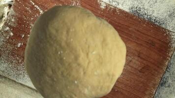 Fresh dough falls on cutting board. View from above. Filmed on a high-speed camera at 1000 fps. High quality FullHD footage video