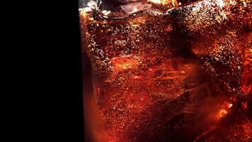 Bubbles in a glass of cola with ice. Filmed on a high-speed camera at 1000 fps. High quality FullHD footage video