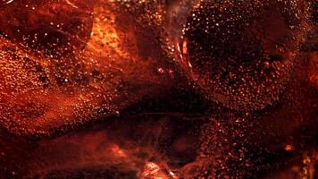 Bubbles in a glass of cola with ice. Filmed on a high-speed camera at 1000 fps. High quality FullHD footage video
