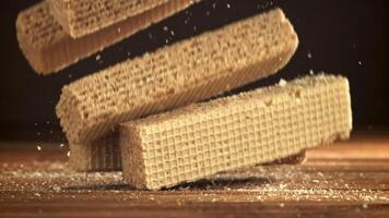 Waffles fall on a wooden table. Filmed on a high-speed camera at 1000 fps. High quality FullHD footage video