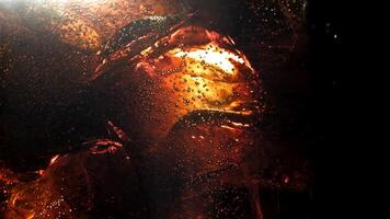 Bubbles in a glass of cola with ice. Filmed on a high-speed camera at 1000 fps. High quality FullHD footage video