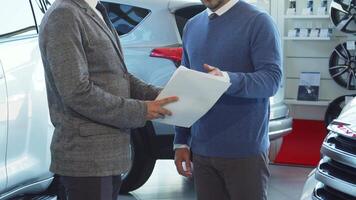 Business professionals engage in a contract discussion and seal the deal with a handshake video