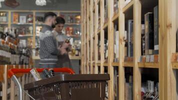 Engaging conversation between shop assistant and customer over wine selection video