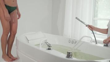 Joyful woman immersing herself in a whirlpool bath for a rejuvenating hydromassage video