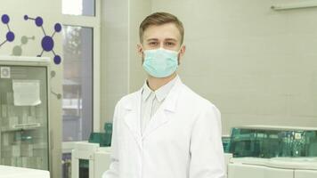 Confident lab assistant smiles while turning to the camera in a modern laboratory video