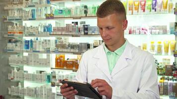 Smiling druggist using tablet in a vibrant pharmacy video