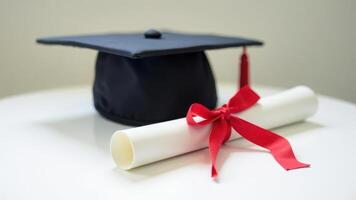 Graduation cap and diploma with red ribbon symbolizing achievement and new beginnings photo