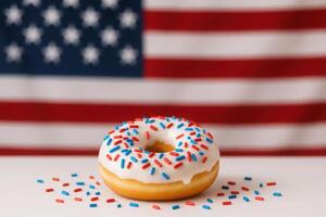Glazed donut with red, white, and blue sprinkles in front of american flag background. National Donut , Doughnut day photo