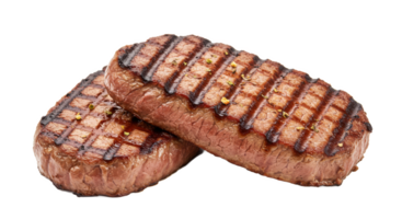 Two grilled steaks stacked on each other showing grill marks and seasoning png