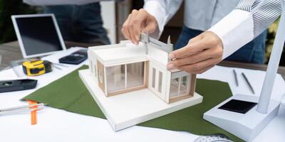 Sustainability and Design Precision. Architects using tools to ensure accuracy in a sustainable building model. photo