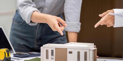Sustainability and Architectural Design. Professionals discussing a sustainable building model. photo
