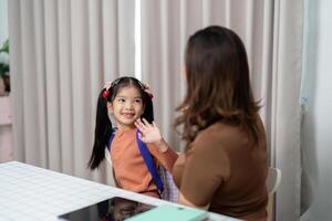 Back to School and Excited Preparations. A mother and daughter get ready for school with enthusiasm and joy. photo